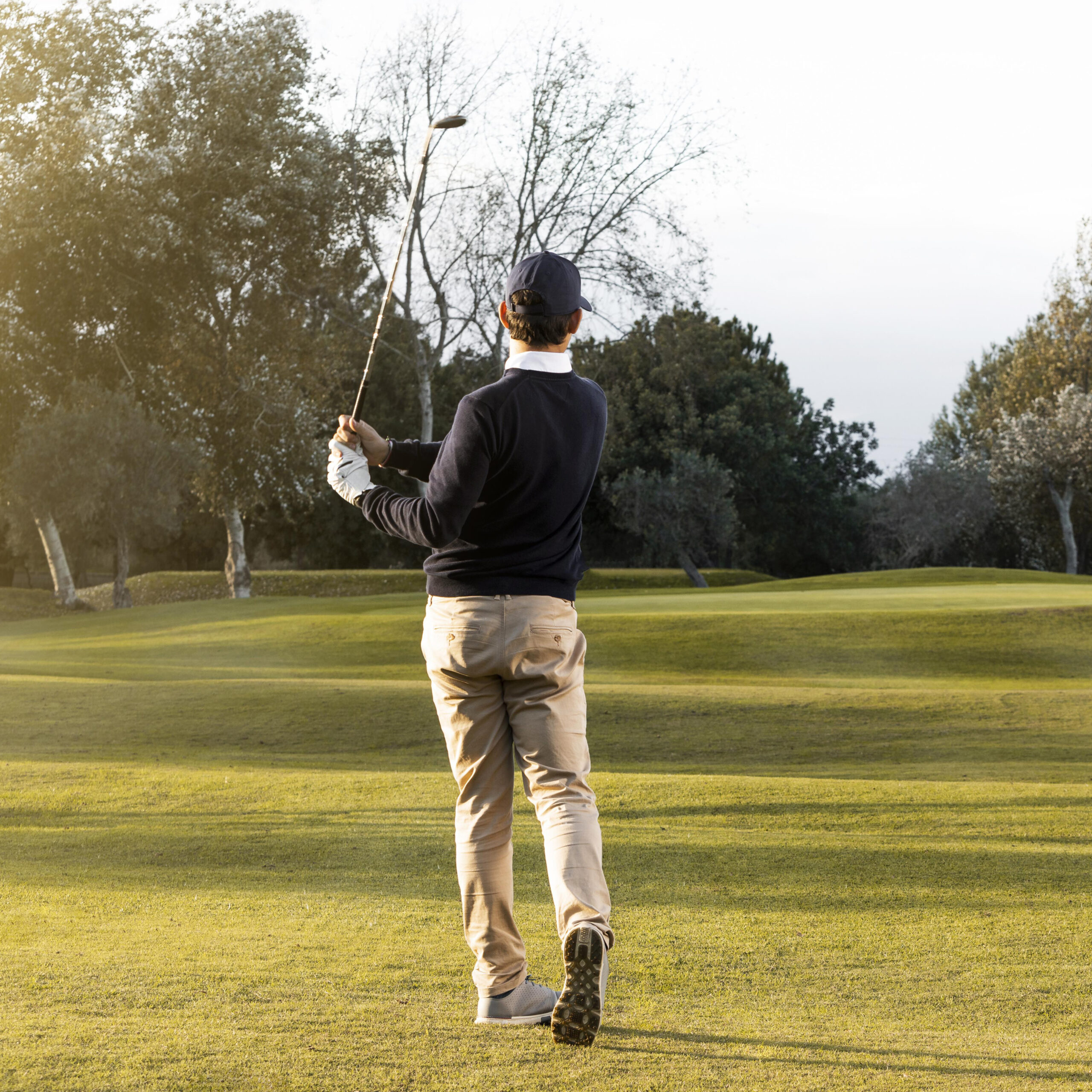 back-view-man-grassy-golf-field-1